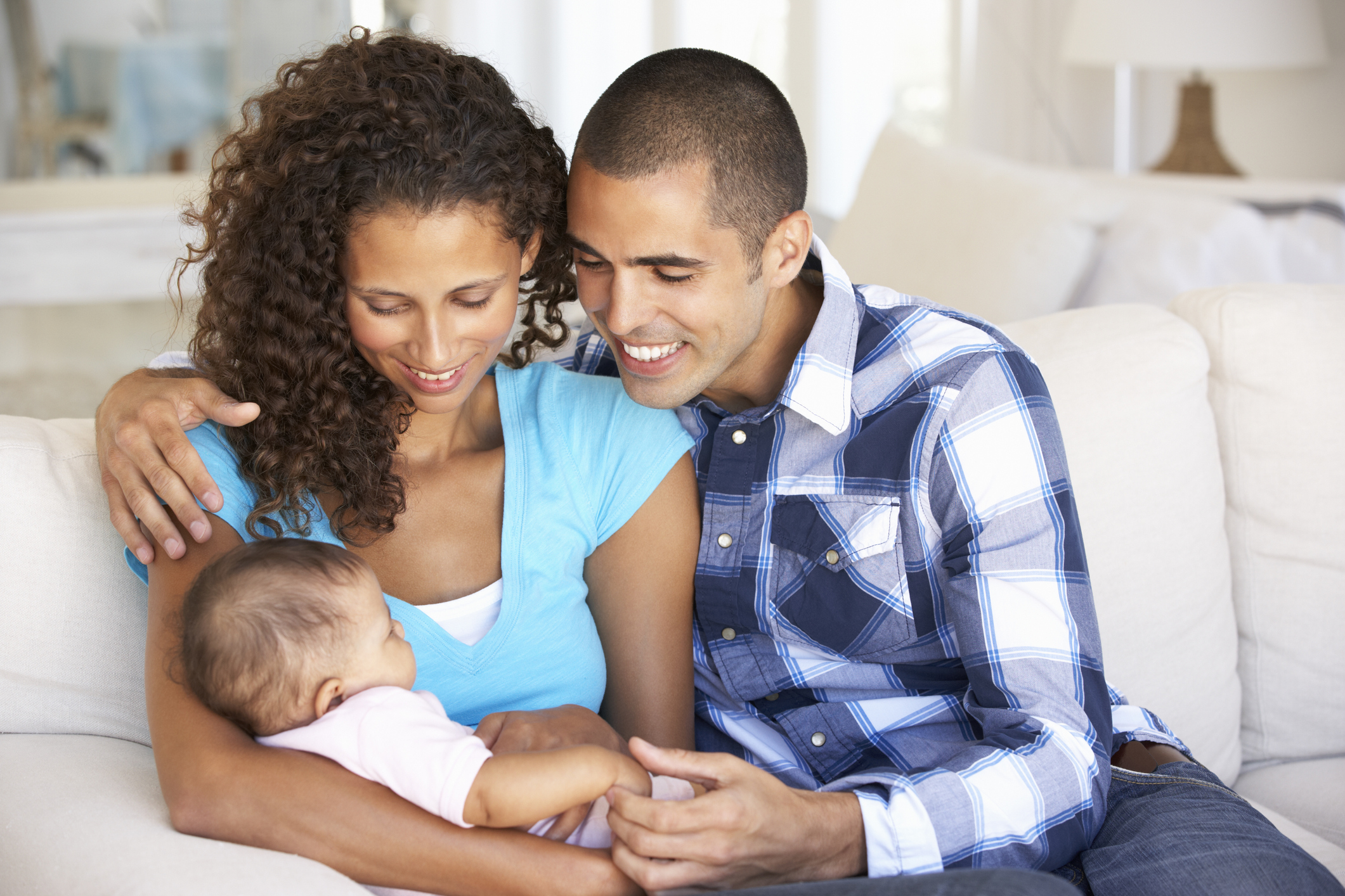 Father supporting mother who is about to breastfeed 