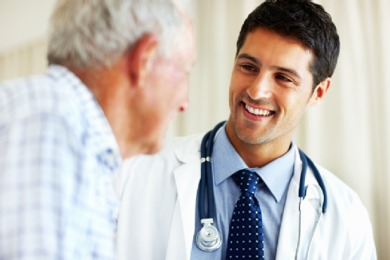 Elderly man receiving advice from male doctor