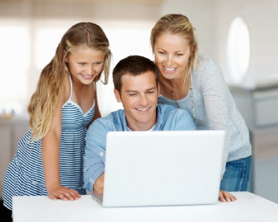 Man using a laptop with his family