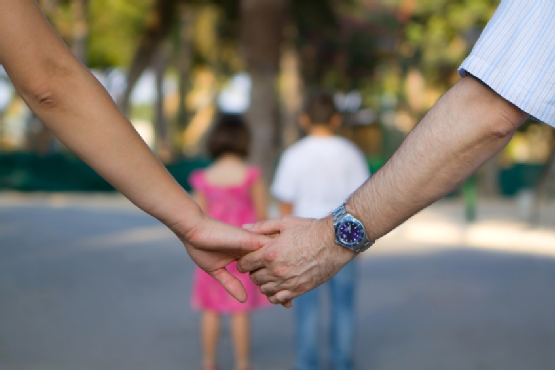 Parents Holding Hands with Kids in Front