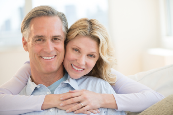 Loving Woman Embracing Man From Behind At Home