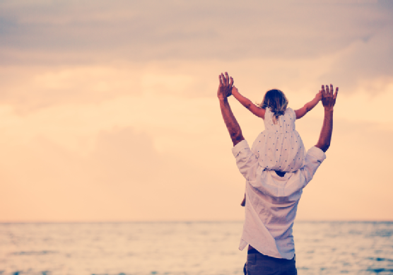 Father and Daughter Playing Together at the Beach at Sunset