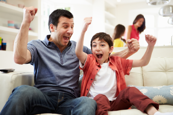 Father And Son Watching Sports On TV